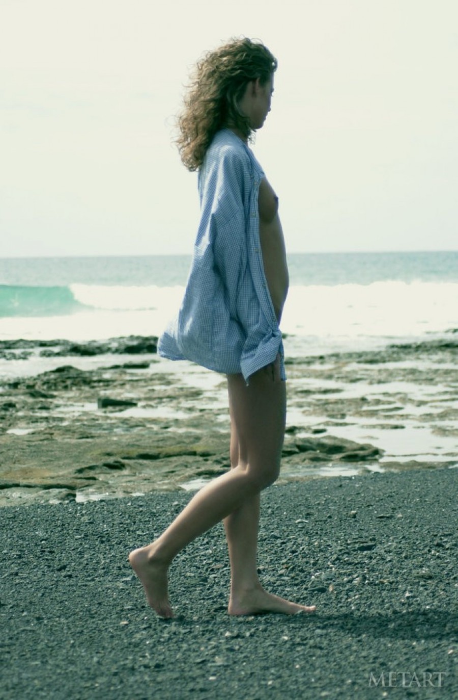 Curly haired blondie posing on the beach