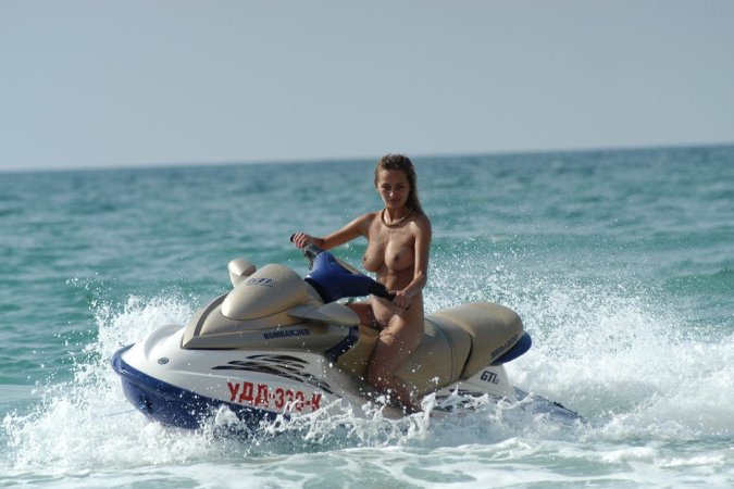 Wild girl doing some naked jet skiing photo 2