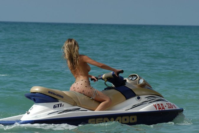 Wild girl doing some naked jet skiing photo 5