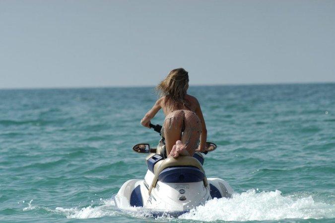 Wild girl doing some naked jet skiing photo 7