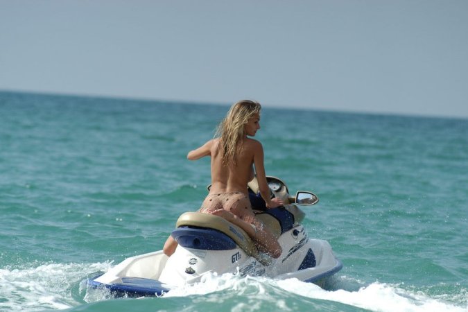 Wild girl doing some naked jet skiing photo 18