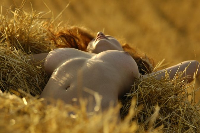 Stockinged cutie relaxes in a pile of hay photo 9