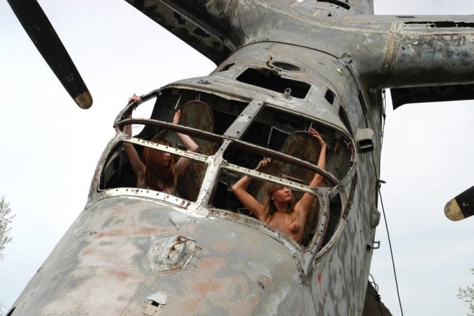 Hot lesbians pose in the ruined plane. photo 11
