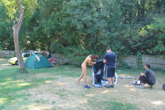 Daring babe walks around in public naked photo 2