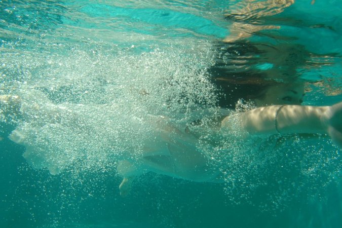 Slim babe with big boobs swims in the outdoor pool photo 1