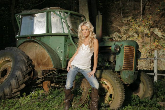 Blondie masturbates in her old tractor. photo 8