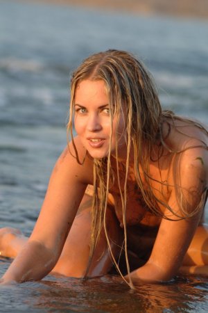 Skinny cutie poses naked in the shallow waters photo 9