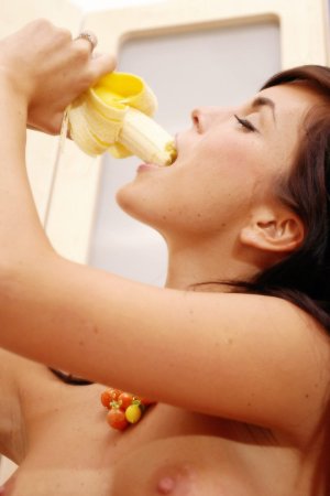 Busty brunette is having solo and eating tasty fruits photo 2