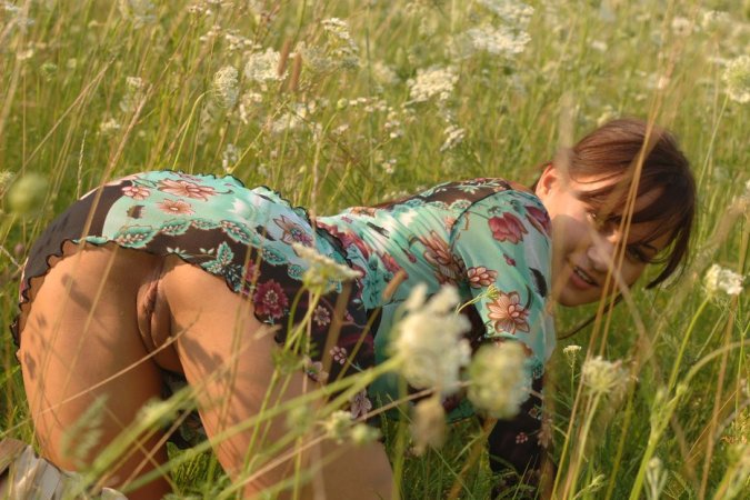 Naked chick lies down in the middle of the meadow. photo 13
