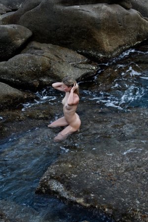 Frisky babe swims naked in the sea photo 14