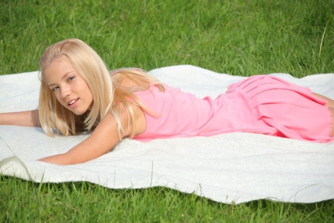 Ideal blondie in pink plays with bananas outdoors. photo 18