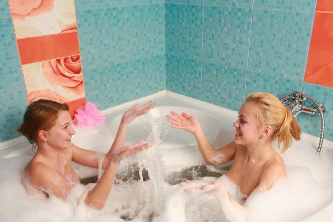 Two chicks are enjoying closeness in the bathtub photo 5