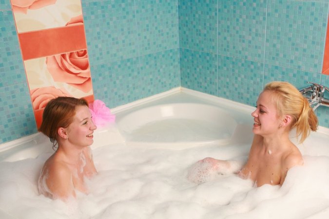 Two chicks are enjoying closeness in the bathtub photo 10