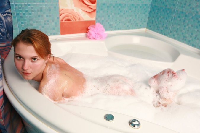 Two chicks are enjoying closeness in the bathtub photo 13