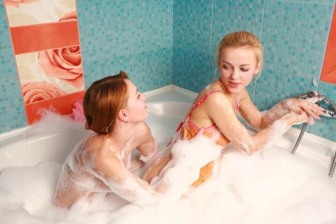 Two chicks are enjoying closeness in the bathtub photo 17