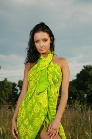 Brunette wearing green dress is having solo outdoors photo 5