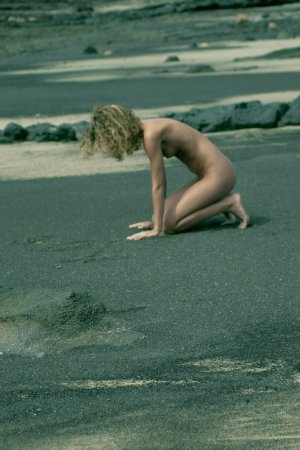 Curly haired blondie posing on the beach photo 3