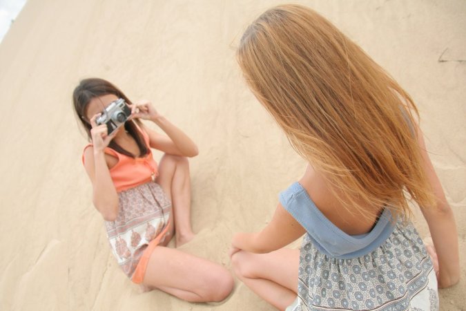 Naked girlfriends fool around with a camera on a beach. photo 6