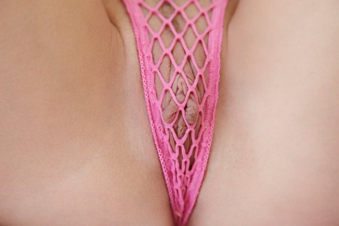 Busty brunette wearing fishnet is enjoying sweet solo photo 19