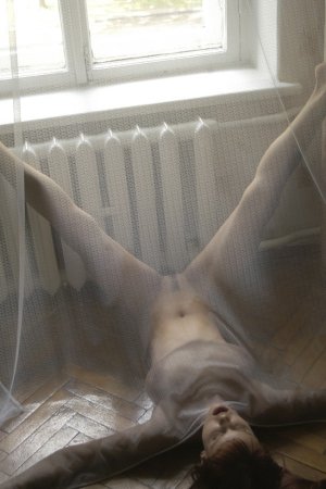 Slim babe spreads her long legs photo 3