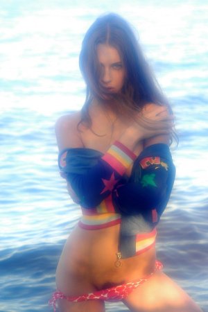 Chick frees small tits in the sea. photo 2