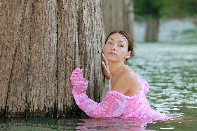 Hottie undresses after taking a swim in the river. photo 4