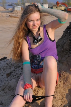Naked brunette plays in the sand photo 8