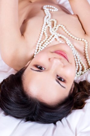 Dark-haired chick plays with her favorite pearl beads. photo 6