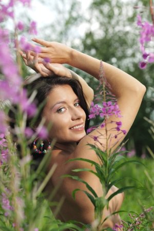 Tender brunette is showing solo skills on green grass photo 1