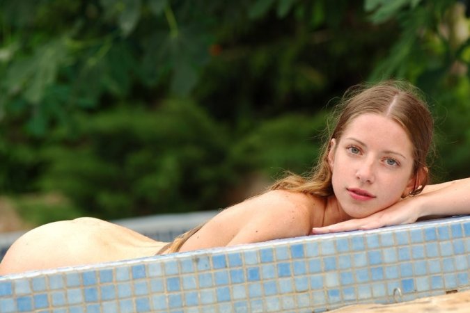 Sweet blonde is having sweet solo in the pool photo 12