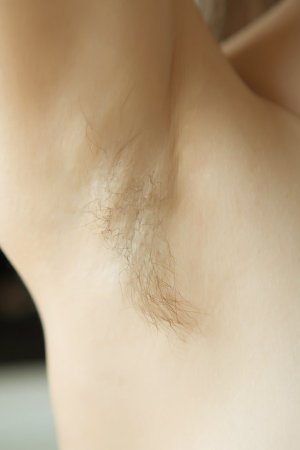 Adorable skinny babe displays her hairy pussy photo 2
