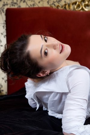 Lovely brunette on the big red sofa photo 2