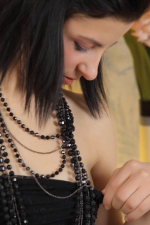 Dark-haired chick caresses herself with beads photo 18