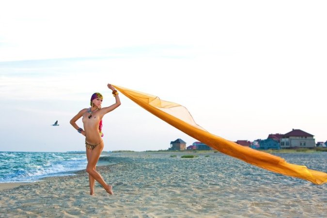 Hot lady in colorful bikini is having solo on the beach photo 3