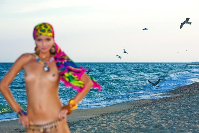 Hot lady in colorful bikini is having solo on the beach photo 9
