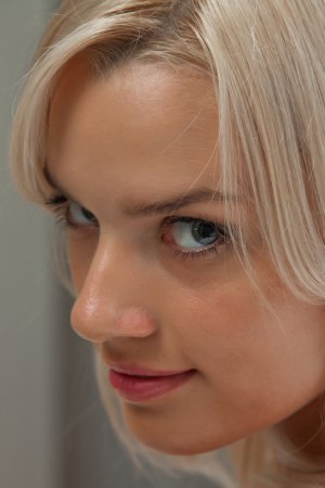 Voluptuous blondie takes off her white outfit photo 6