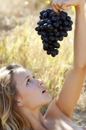 Naked hottie eats grapes in the garden photo 18