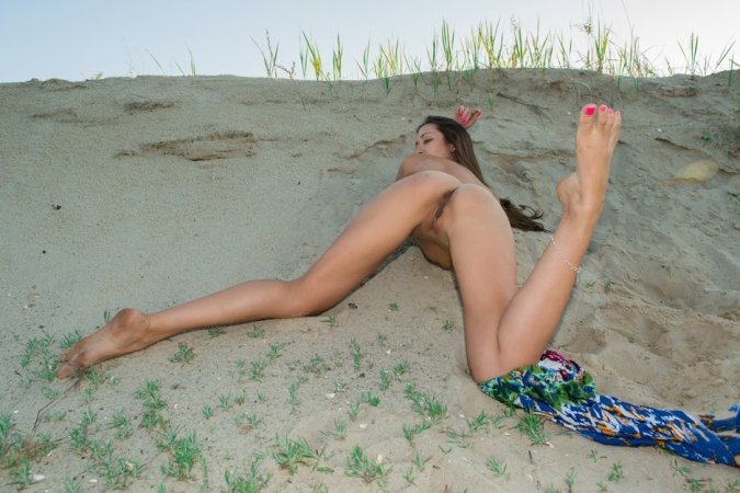 Naked babe works out on the beach photo 2