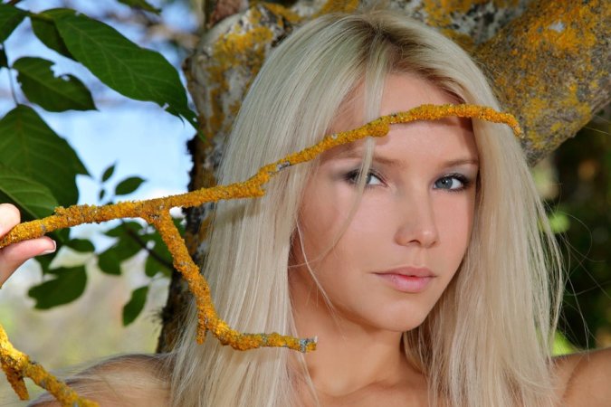 Busty blondie in leather belt spends day in the forest. photo 5