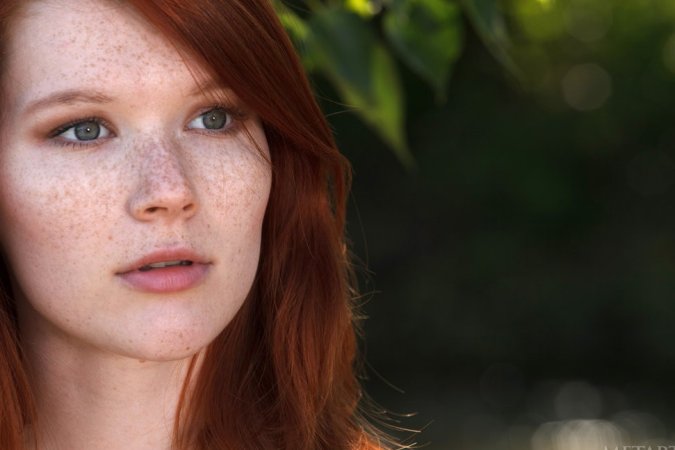 Skinny redhead getting naked in a creek photo 5