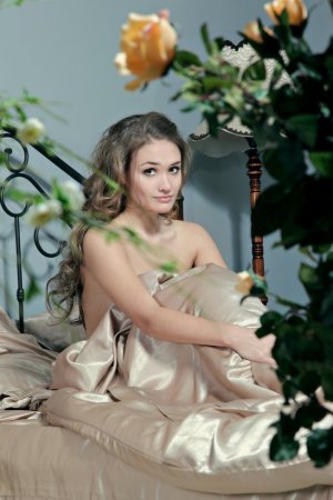 Brunette plays with pussy on silk sheet photo 18