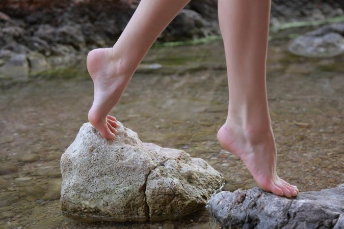 Lovely brunette is getting naked outdoors photo 2