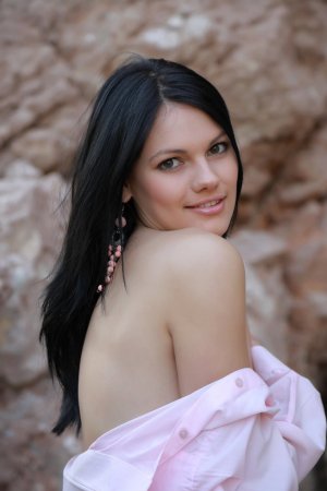 Lovely brunette is getting naked outdoors photo 3