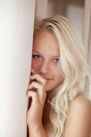 Naked blondie looks out of the window. photo 2