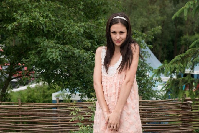 Cutie undresses on soft green grass photo 1