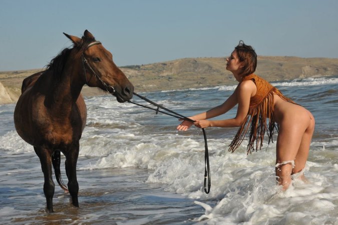 Brunette gal posing with her horse photo 19
