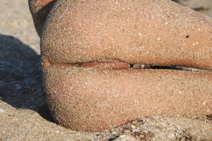Adorable brunette posing on the beach with passion photo 14