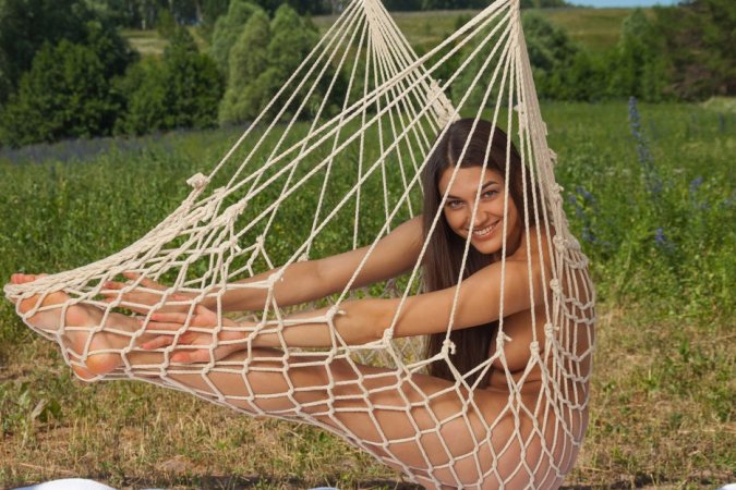 Adorable girl naked in her hammock photo 17