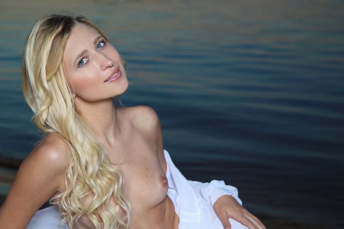 Naked babe gets her doggy orgasms on the beach photo 11