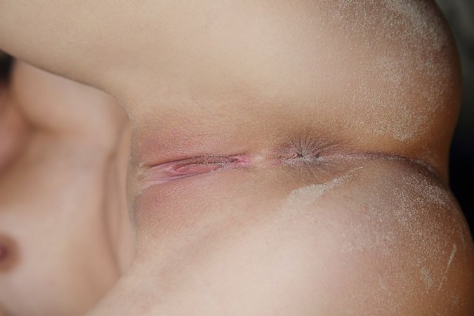 Naked babe gets her doggy orgasms on the beach photo 15